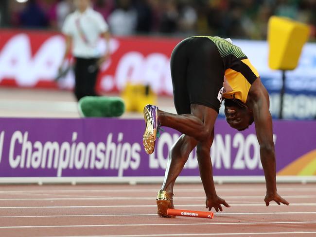 Bolt’s legs begin to give way and he falls forward. Picture: AFP