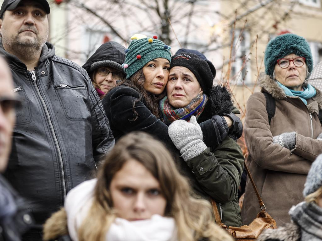 Residents embrace during a vidual for the victims held in Strasbourg. Picture: AP