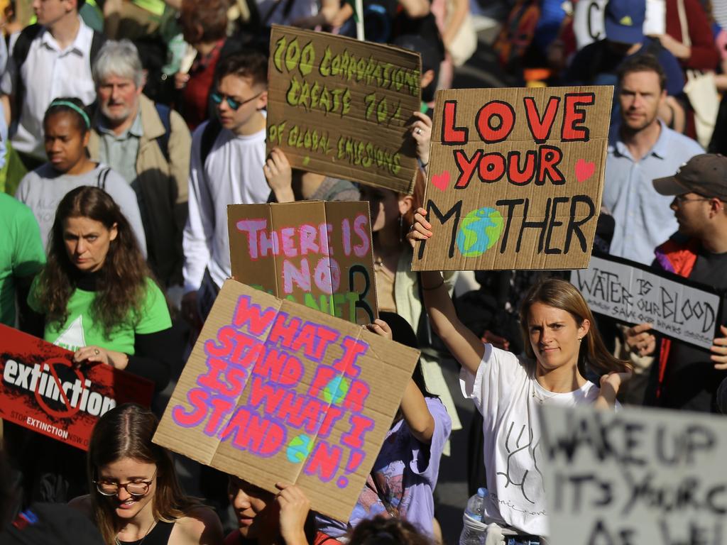 Protesters with placards participate in The Global Strike 4 Climate rally in Sydney last year. Coronavirus has inadvertently achieved a reversal in carbon emissions. Picture: AAP Image