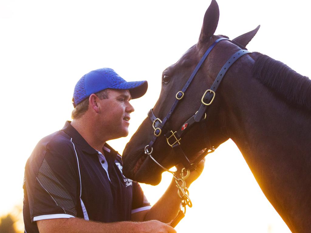 Ben Smith walks In Her Time home, stopping to give her a pat at Broadmeadow Racecourse after early morning trackwork. Picture: Jenny Evans