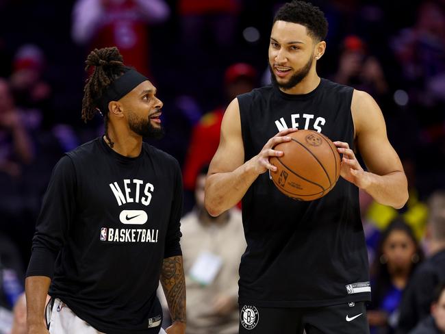 PHILADELPHIA, PENNSYLVANIA - MARCH 10:  Patty Mills #8 and Ben Simmons #10 of the Brooklyn Nets take the court for warm ups before the game against the Philadelphia 76ers at Wells Fargo Center on March 10, 2022 in Philadelphia, Pennsylvania. NOTE TO USER: User expressly acknowledges and agrees that, by downloading and or using this photograph, User is consenting to the terms and conditions of the Getty Images License Agreement. (Photo by Elsa/Getty Images)