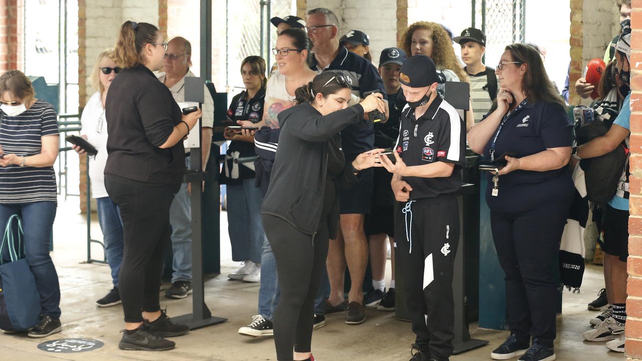 Collinwood and Carlton fans scan their QR tracking codes to enter the ground. Picture: Getty Images