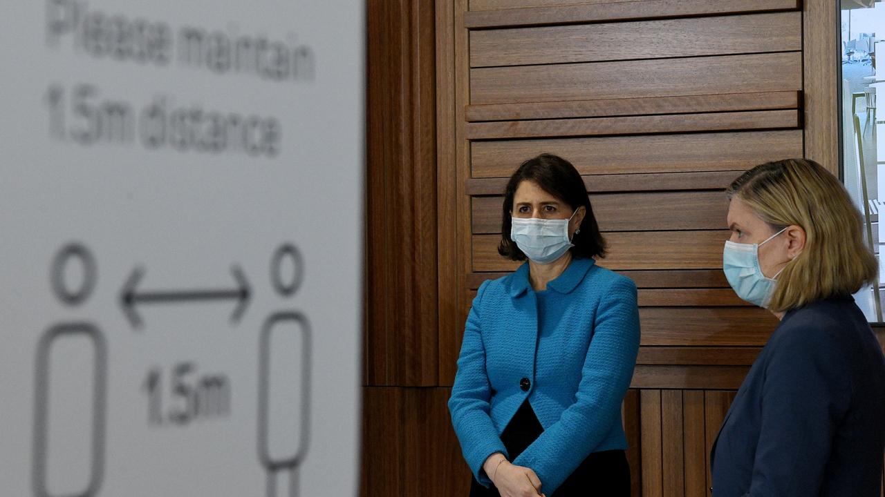 (L-R) NSW Premier Gladys Berejiklian and NSW chief health officer Dr Kerry Chant wear face masks during a press conference.