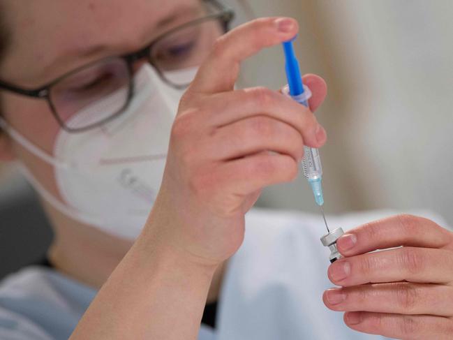 Medical personnel prepares a syringe with the Pfizer-BioNTech vaccine against Covid-19 at the pharmacy of the vaccination center at the Robert Bosch hospital in Stuttgart, southern Germany, on February 12, 2021. (Photo by THOMAS KIENZLE / AFP)