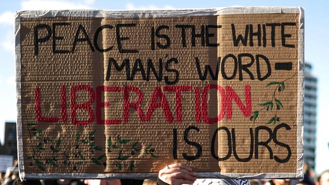 A protester holds a placard while taking part in the 'National March For Palestine'. Picture: AFP