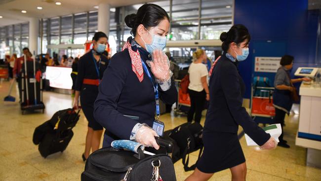 Cabin crew believed to be from flight MU749 from Wuhan China arrive at Sydney Airport. Picture: Flavio Brancaleone