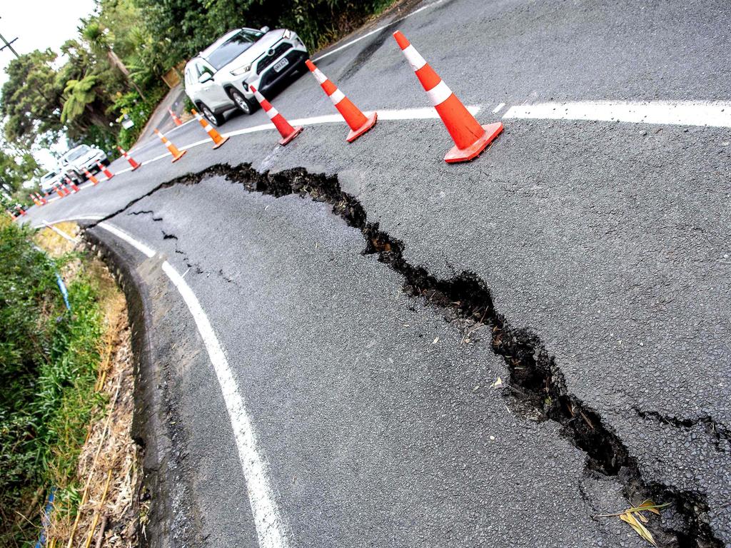 Damage to a road after flash flooding in Auckland. Picture: AFP