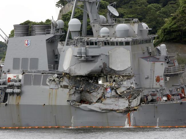 The damaged USS Fitzgerald is docked at the US Naval base in Yokosuka, south-west of Tokyo, after colliding with Philippine-flagged container ship ACX Crystal off Japan. The 8,315-ton destroyer had its starboard side badly damaged, with a mechanical room and two sleeping compartments destroyed and flooded. Picture: AP Photo/Eugene Hoshiko