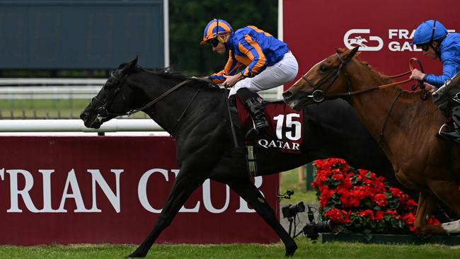RL Moore riding Camille Pissaro crosses the finish to win the 185th Qatar Prix du Jockey Club horse race at the Chantilly race course, north of Paris on June 1, 2025. (Photo by Hugo MATHY / AFP)