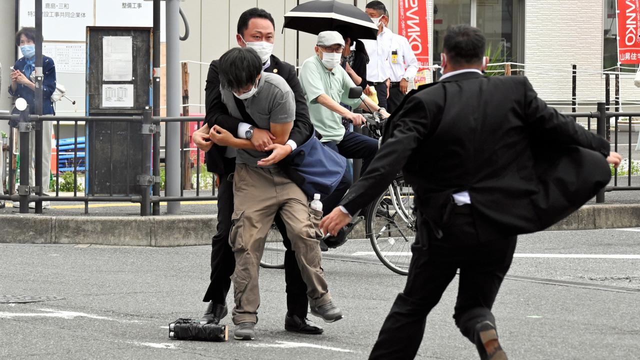 Security police detain the suspected assassin. Picture: Getty