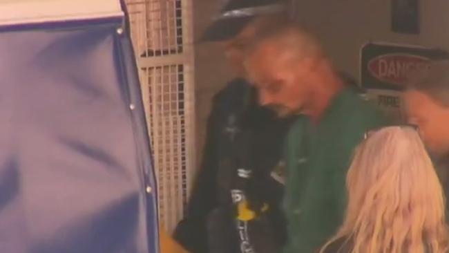 Ben Hoffmann leaves hospital to be taken to Darwin watch house. Picture: 7NEWS