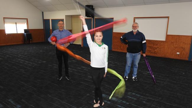 Lidiia Iakovleva at the church hall where she trained. Also pictured is Minister Craig Blackburn and well known local teacher from Manly West State School, Darryl Brown.