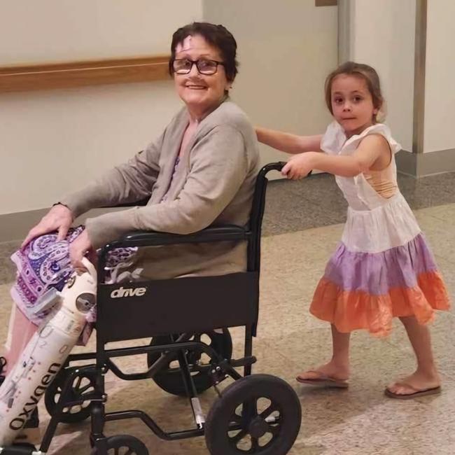 Howard Springs sepsis survivor Tracey McNee, aged 61 when she was afflicted by the life-threatening condition, being wheeled out of hospital by her five-year-old granddaughter. Picture: Supplied