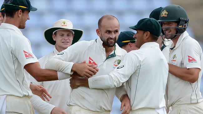 Australian players congratulate Nathan Lyon on snaring his 200th Test wicket.