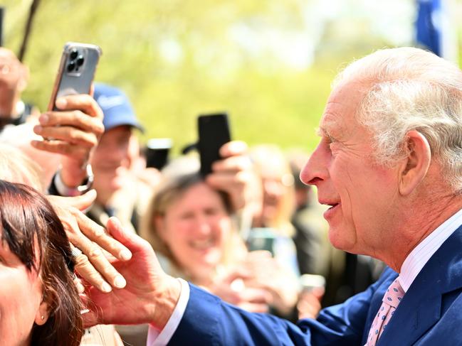 LONDON, ENGLAND - MAY 05: King Charles III greets members of the public along the Mall as preparations continue ahead of the Coronation of King Charles III and Queen Camilla on May 05, 2023 in London, England. The King was joined by the Prince and Princess Of Wales. The Coronation of Charles III and his wife, Camilla, as King and Queen of the United Kingdom of Great Britain and Northern Ireland, and the other Commonwealth realms takes place at Westminster Abbey tomorrow. Charles acceded to the throne on 8 September 2022, upon the death of his mother, Elizabeth II.  (Photo by Dan Mullan/Getty Images)