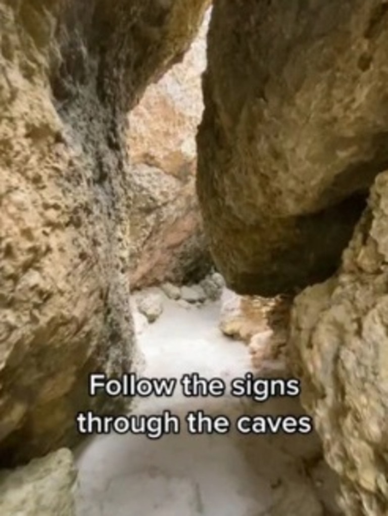 To get to Stokes Bay Beach you have to make your way through narrow caves. Picture: TikTok