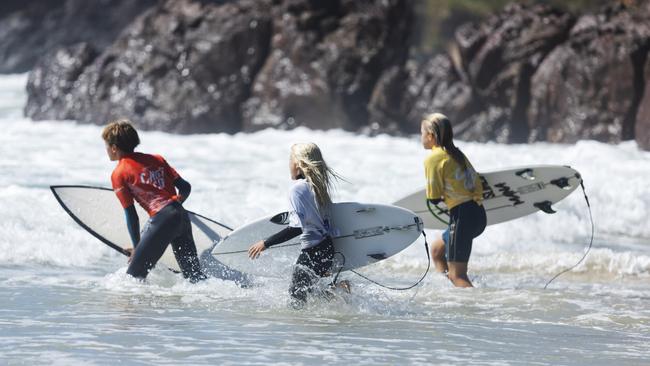 Surfers enter the waves at the Reflections Cadet Cup at Bonny Hills.