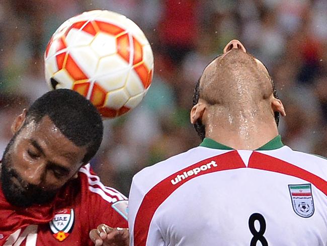 BRISBANE, AUSTRALIA - JANUARY 19: Morteza Pouraliganji of Iran and Mohamed Abdulrahman of the United Arab Emirates compete for the ball during the 2015 Asian Cup match between IR Iran and the UAE at Suncorp Stadium on January 19, 2015 in Brisbane, Australia. (Photo by Bradley Kanaris/Getty Images) *** BESTPIX ***