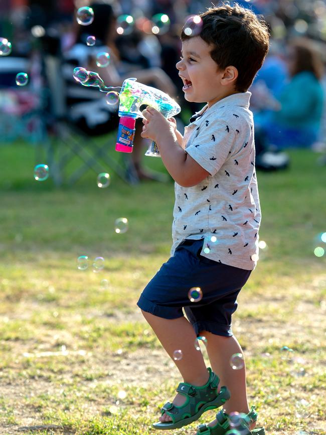 A boy enjoys blowing bubbles in Melbourne. Picture: Jay Town