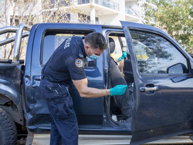 NT Police dust for fingerprints of a allegedly stolen Isuzu ute which was crashed at a busy Darwin CBD intersection. Picture: Floss Adams.