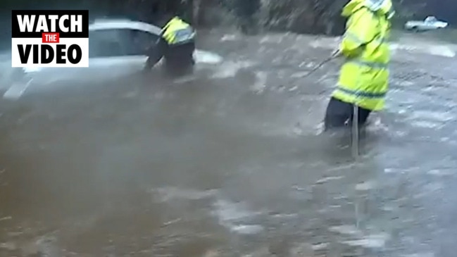 Woman rescued from SUV in floodwaters