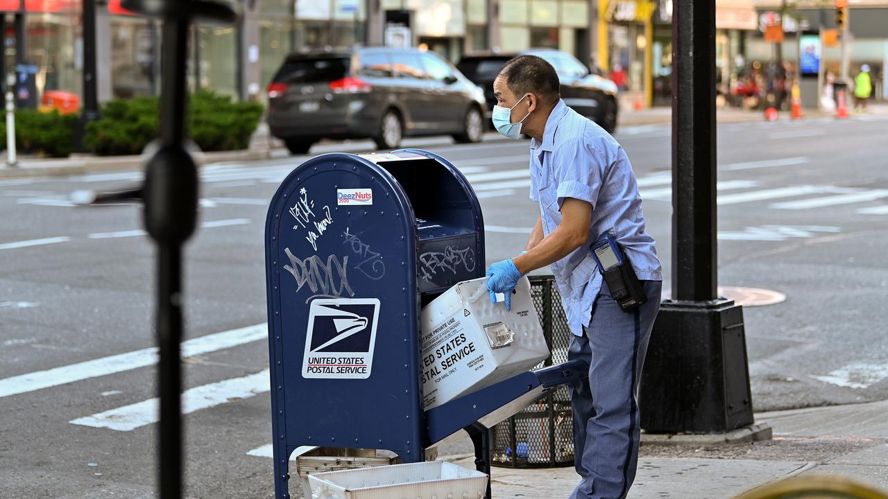 A USPS worker collects mail from a Manhattan post bin. Picture: Dia Dipasupil / Getty Images / AFP