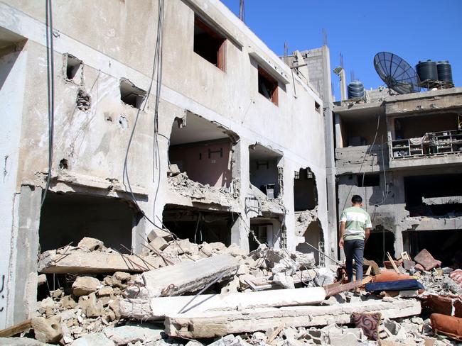 Palestinian citizens inspect damage to their homes caused by Israeli air strikes in Khan Younis, Gaza. Many Gazan citizens have fled to the south following warnings from the Israeli government to do so. Picture: Getty Images