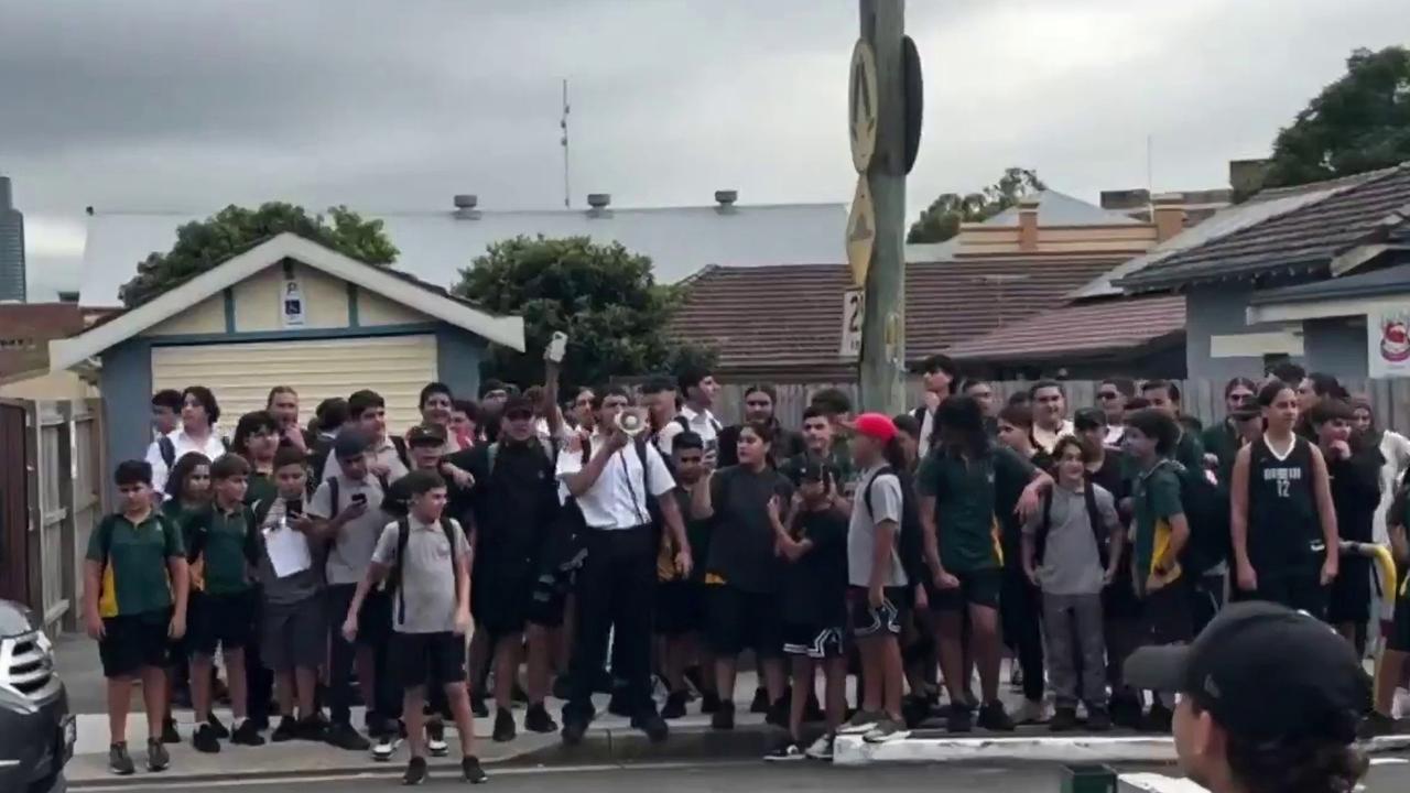 Students gathered outside the school gates to protest the support officer’s suspension. Picture: X