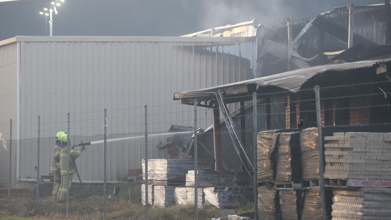 Crews continued to hose the smouldering factory. Picture: Alan Barber