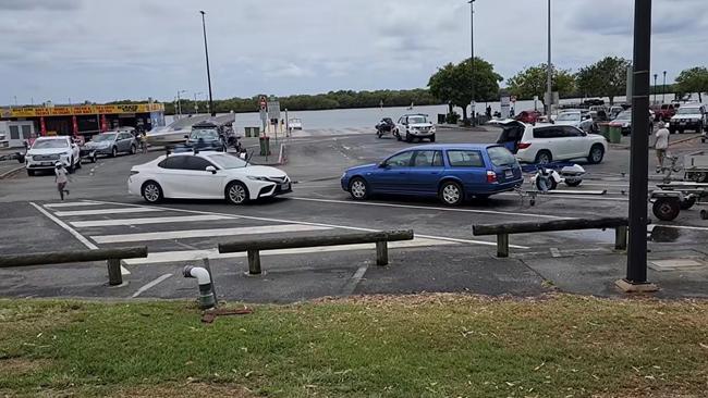 Dramatic footage shows a man towing a Toyota out of a trailer bay at Jacobs Well Boat Ramp on Saturday after it had blocked him in. Photo: Landos Down Under