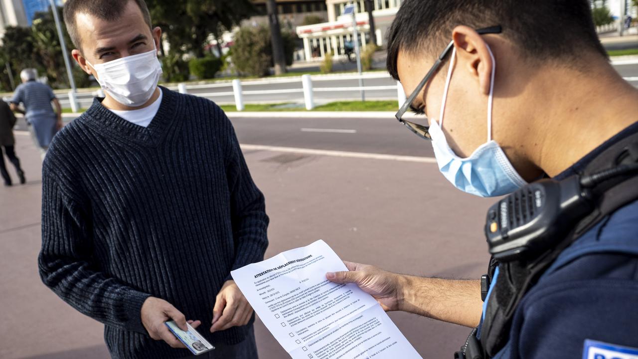 Police officers check COVID attestation papers in Nice, France. Picture: Arnold Jerocki/Getty Images