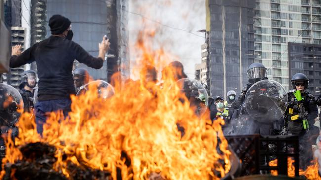 Rubbish bins burn on Spencer St, Melbourne, this week ahead of clashes between anti-war activists and police around the Land Forces International Defence Expo. Picture: Darrian Traynor/Getty Images