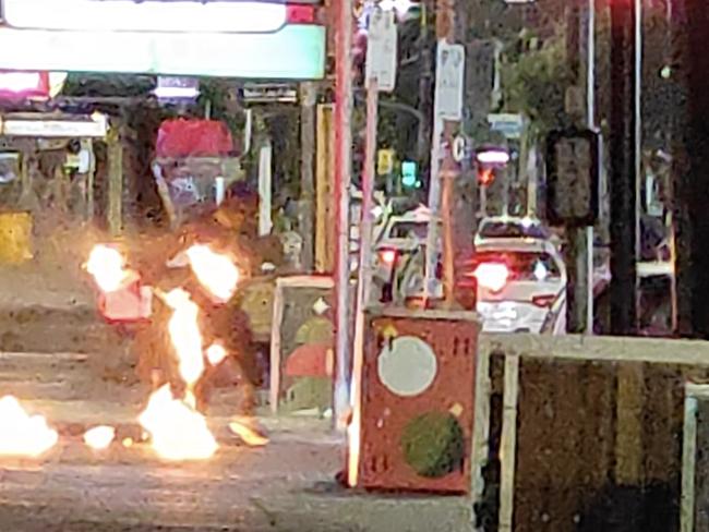 Screen grabs of three men setting fire to the Lux night club in Chapel Street South Yarra.