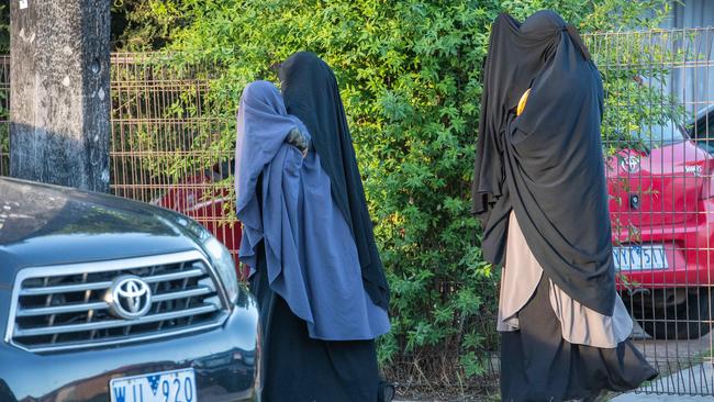 Women arrive at the Werribee home of Hassan Khalif Shire Ali’s father. Picture: Jason Edwards