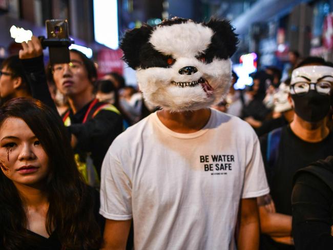 People shout slogans in front of a line of policemen in the Lan Kwai Fong area during Halloween in Hong Kong. Picture: AFP