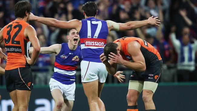 Ryan Griffen and Shane Mumford dejected as Toby McLean and Tom Boyd celebrate. Picture: Phil Hillyard