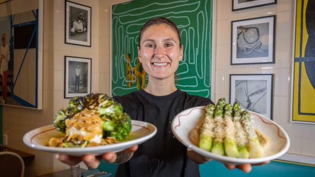 Senior chef Caitlin Lemish with two of the plant-based dishes at Africola restaurant in Adelaide’s East End. Picture: Ben Clark