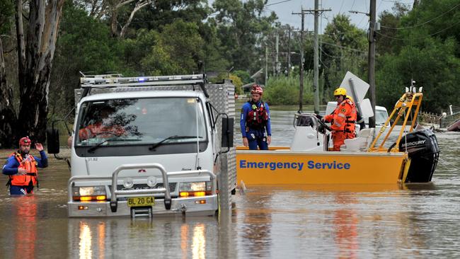 Volunteers from the State Emergency Service (SES) rescue animals from flooded farm houses in western Sydney on Thursday, as the area faces its worst flooding after record rainfall caused its largest dam to overflow. Picture: Muhammad Farooq, AFP.