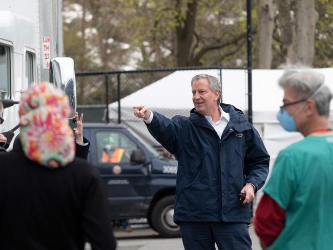 New York City Mayor Bill De Blasio speaks to health workers before visiting a temporary hospital located at the USTA Billie Jean King National Tennis Centre. Picture: AFP