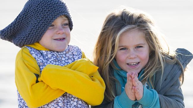 Lizzie Criddle, 5, and Gidget Kowalski, 7, prepare for a wintry blast. Picture: JENNY EVANS