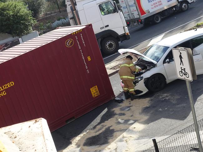 A shipping container hit a car after a truck crashed into the Napier St bridge in March, 2018. Picture: Martin Wurt