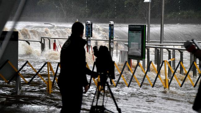 A cameraman takes footage of the wild deluge. Picture: Saeed Khan