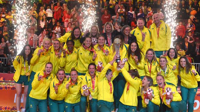 TOPSHOT - Australian players hold their trophy as they celebrate winning the final of the Netball World Cup against England, in Cape Town on 06 August 2023. (Photo by RODGER BOSCH / AFP)