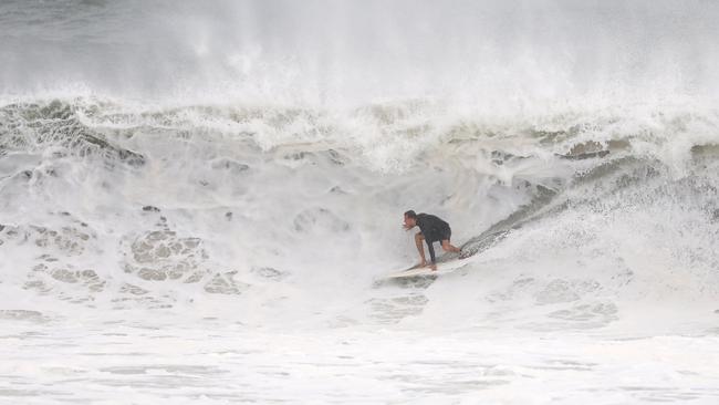 A surfer at Main Beach in Byron Bay. Picture: Rohan Kelly