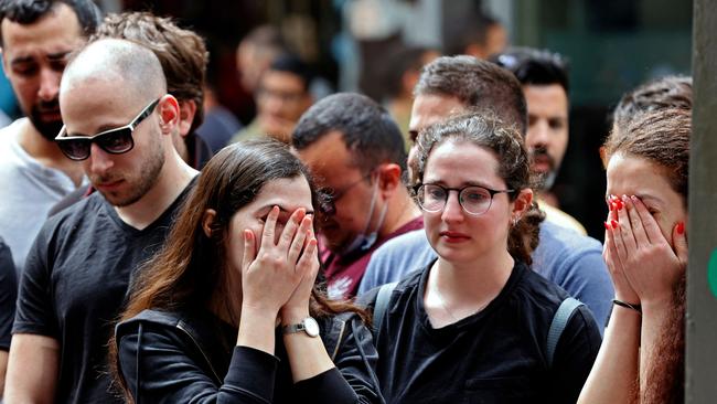 Israelis react at the site of a shooting attack the previous night at Dizengoff Street in the centre of Israel's Mediterranean coastal city of Tel Aviv on April 8.