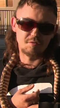 Man interviewed with epic mullet holding a snake