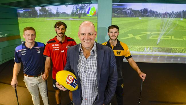 SANFL CEO Darren Chandler with league players and keen golfers Cooper Dahms (Central District), Callum Park (West Adelaide) and Jonty Scharenberg (Glenelg) at the new X-Golf in West Lakes. Picture: Roy Vandervegt