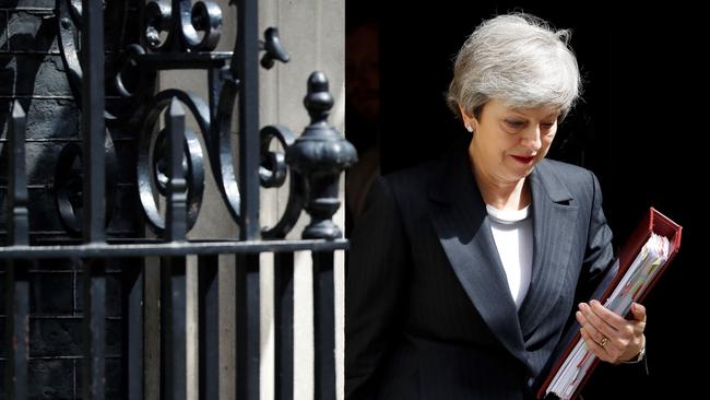 Theresa May leaves 10 Downing Street ahead of the weekly Prime Minister's Questions. Picture; AFP.