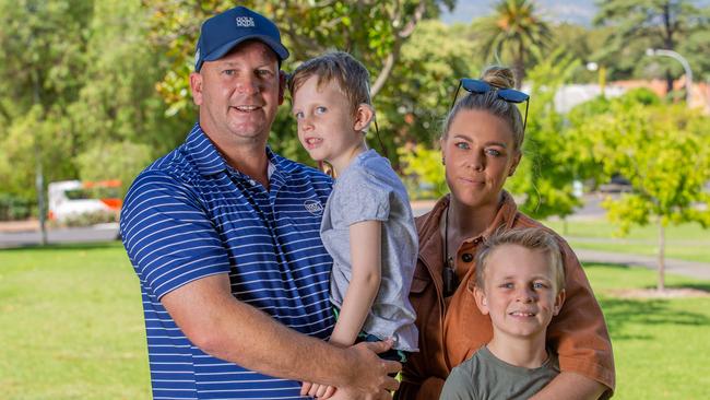 Victims of the cochlear implant scandal Dale and Lauren Smedley and their kids Reid, 8, and Logan, 5. Picture: Ben Clark