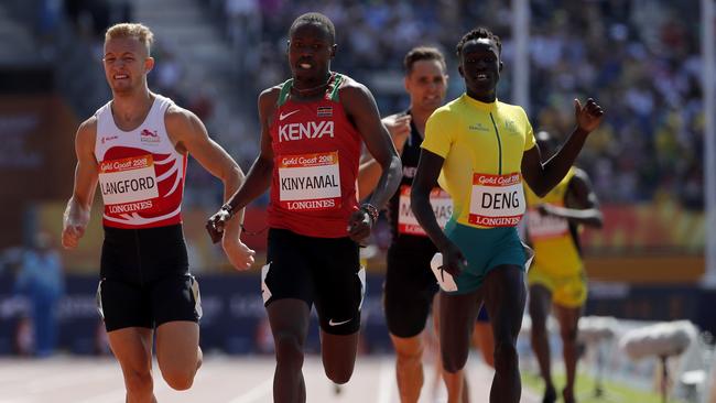 Kenya's Wycliff Kinyamal leads England's Kylie Langford, left, and Australia's Joseph Deng to the finish line in their men's 800m heat at Carrara Stadium. Picture: AP